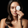 Image of model holding up a cotton pad
